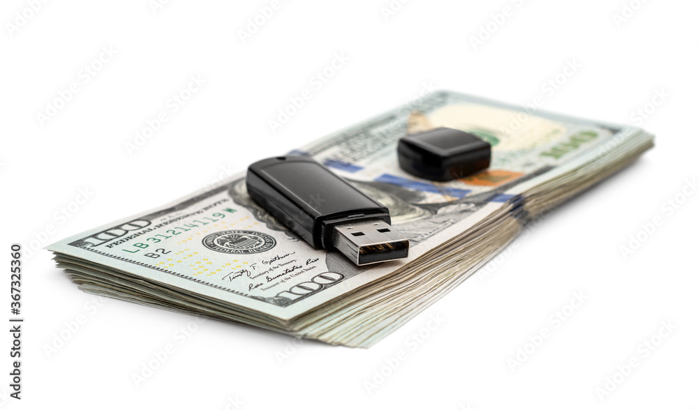 Flash drive on stack of dollar bills. Isolated on white. Flash drive on stack of dollar bills. Isolated on white.