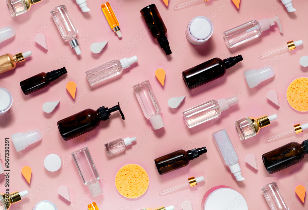 Skin care and mke up set. Hilauronic acid, lotion, serum and gel on abstract pink background. Top horizontal view Skin care and mke up set. Hilauronic acid, lotion, serum and gel on abstract pink background. Top horizontal view