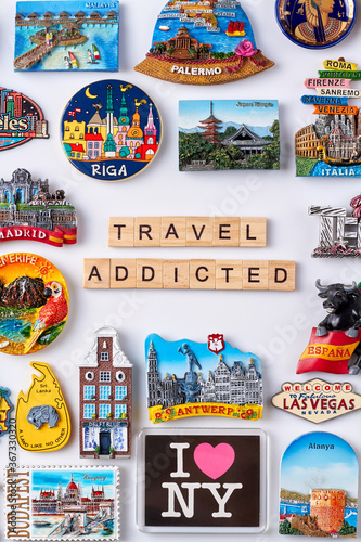 Flat lay travel collection of souvenirs. Concept of travel addicted man.