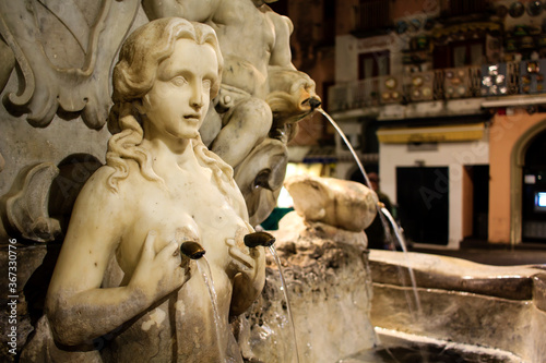 Element of the Saint Andrew's Fountain at Piazza del Duomo in Amalfi town, Amalfi coast, Italy. Fountain represents a woman holding her breasts with water pouring from her nipples. 
