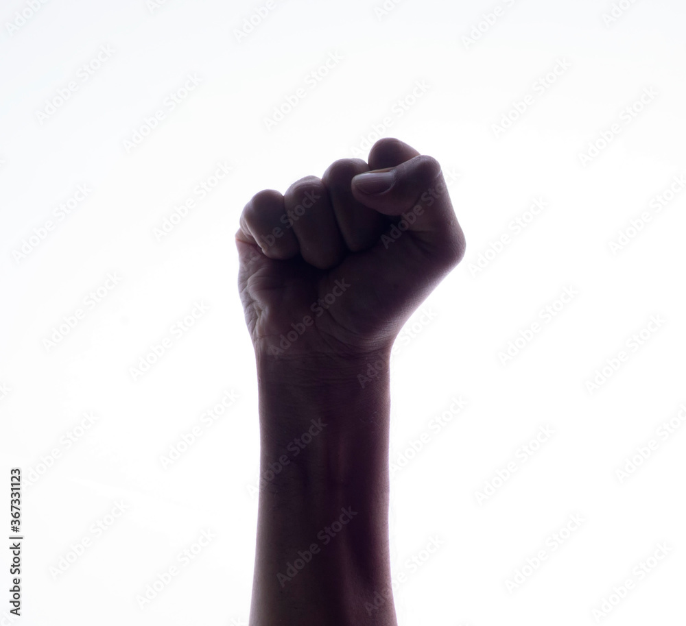 Backlight of a Hand with clenched a fist, isolated on a white background. Struggle and resistance concept. Freedom Backlight of a Hand with clenched a fist, isolated on a white background. Struggle and resistance concept. Freedom