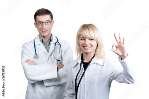 Man and woman in white coats of doctors with stethoscopes on a white background in isolation