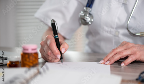 Female doctor writing prescription