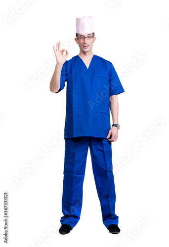 A man in a blue doctor suit and cap on a white background, isolated © Mykola