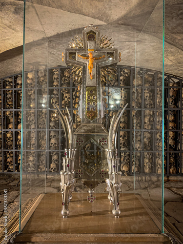  cross in a display case and skulls in the background are in the Brigittenkirche in Gdansk in Poland photo