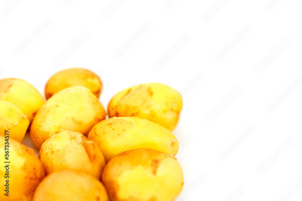 Raw potatoes on white background. Fresh potatoes on isolated. Early harvest. Washed vegetables. Selective focus. Concept of culinary skill. Place for an inscription or logo