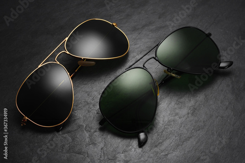 Old fashion aviator sunglasses on black slate background.