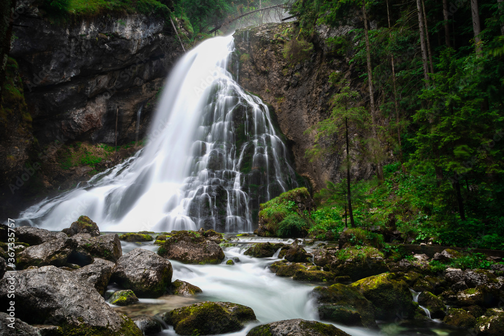 Gollinger Waterfall in Golling an der Salzach near Salzburg, Austria. Stunning view of cascade waterfall over mossy rocks in the Alps with long exposure Gollinger Waterfall in Golling an der Salzach near Salzburg, Austria. Stunning view of cascade waterfall over mossy rocks in the Alps with long exposure