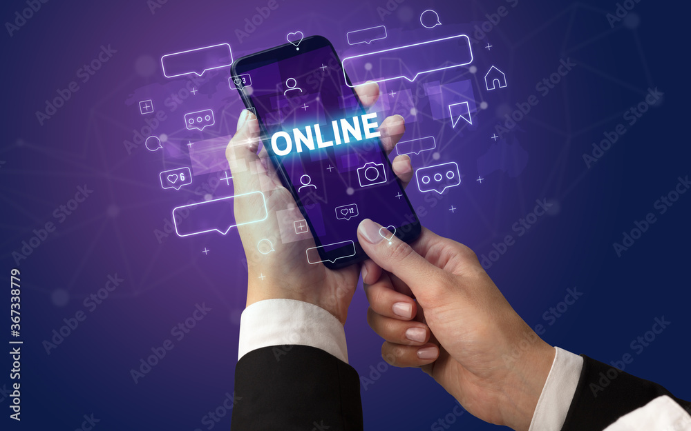 Female hand typing on smartphone with ONLINE inscription, social media concept Female hand typing on smartphone with ONLINE inscription, social media concept