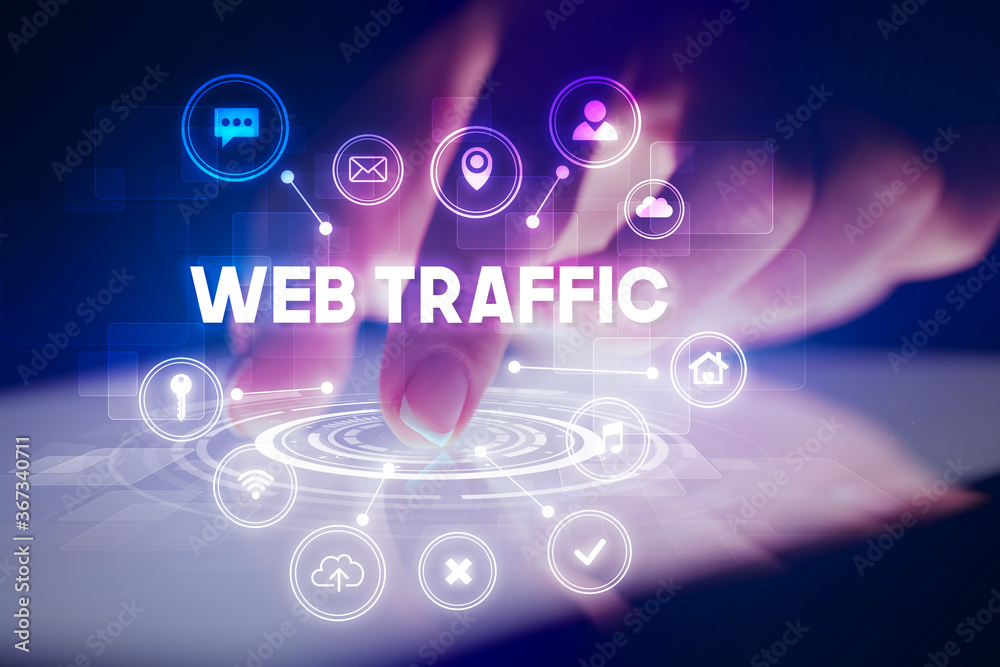 Finger touching tablet with web technology icons and WEB TRAFFIC inscription, web technology concept