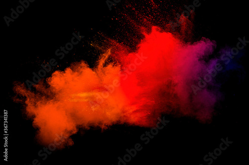 Abstract blurred motion of colorful dust particles on black background.Abstract hot tone color powder overlay texture.