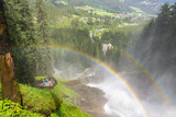 colorful rainbow above a waterfall