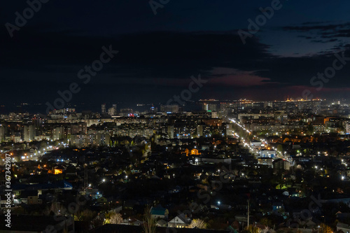 Multi-colored (blue and orange colors) sunset on the city of Saratov. View from the observation deck to the night city.