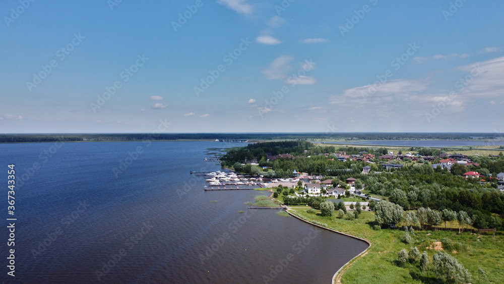 Volga river with boats and cargo ship.