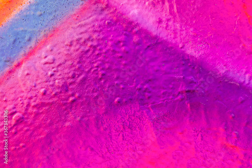 Beautiful bright colorful street art graffiti background. Abstract creative spray drawing fashion colors on the walls of the city. Urban Culture, violet , pink , purple , crimson, blue texture