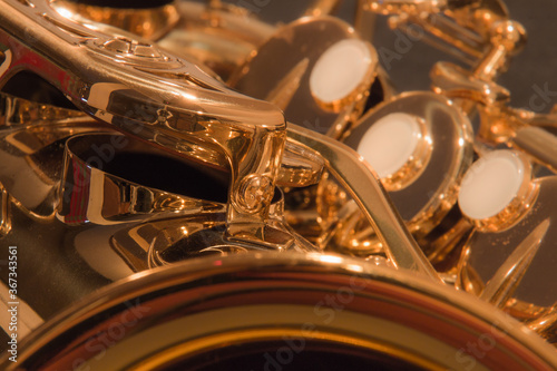 Close up of the mechanics of a brass alto saxophone