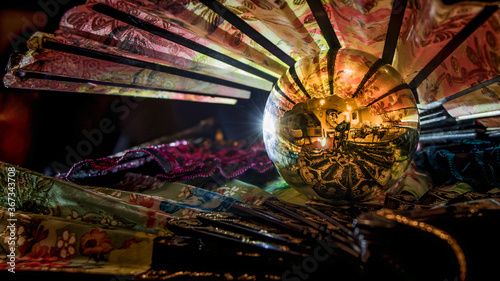 Abstract composition with several Asian fans and a reflective chrome ball