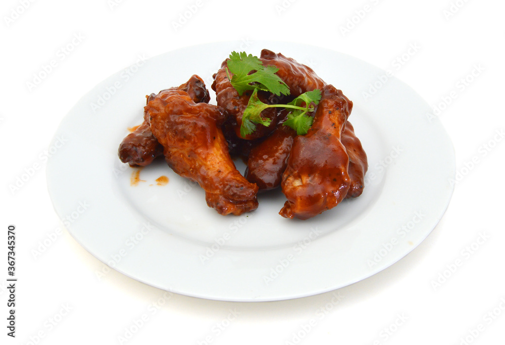 Chicken wings with barbeque sauce in white plate on white Chicken wings with barbeque sauce in white plate on white