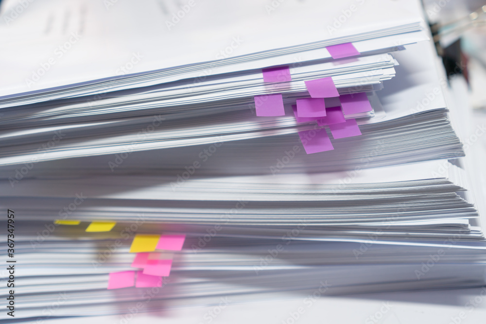 Fototapeta premium Paper stack, Pile of unfinished documents with post it on office desk related to business functions. Stack of business papers for Annual Report file