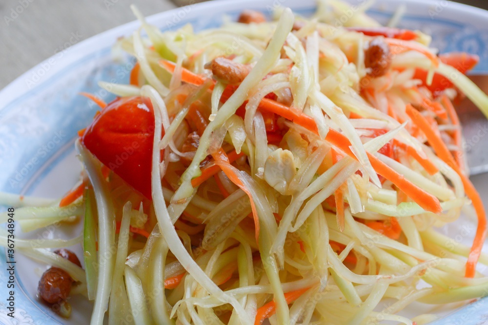 spicy papaya salad on wood floor - Thailand healthy food spicy papaya salad on wood floor - Thailand healthy food