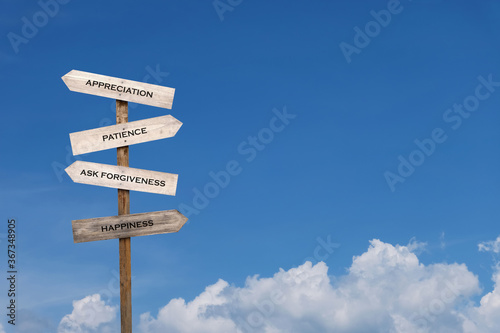 wooden sign and sky. ways to happiness. appreciation and satisfaction with what you received. be patient when encountering obstacles and problems. ask for forgiveness the things that made a mistake.