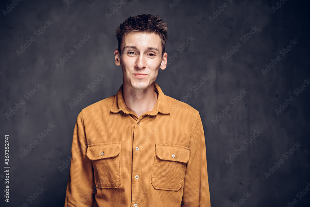 Smiling young caucasian man on dark background Smiling young caucasian man on dark background