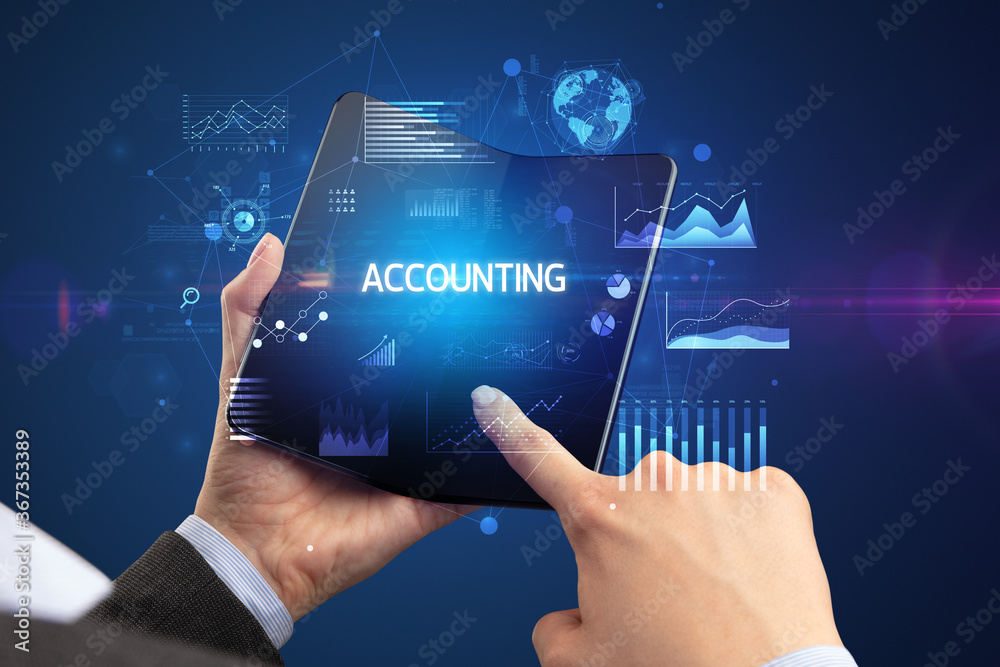 Businessman holding a foldable smartphone with ACCOUNTING inscription, successful business concept Businessman holding a foldable smartphone with ACCOUNTING inscription, successful business concept