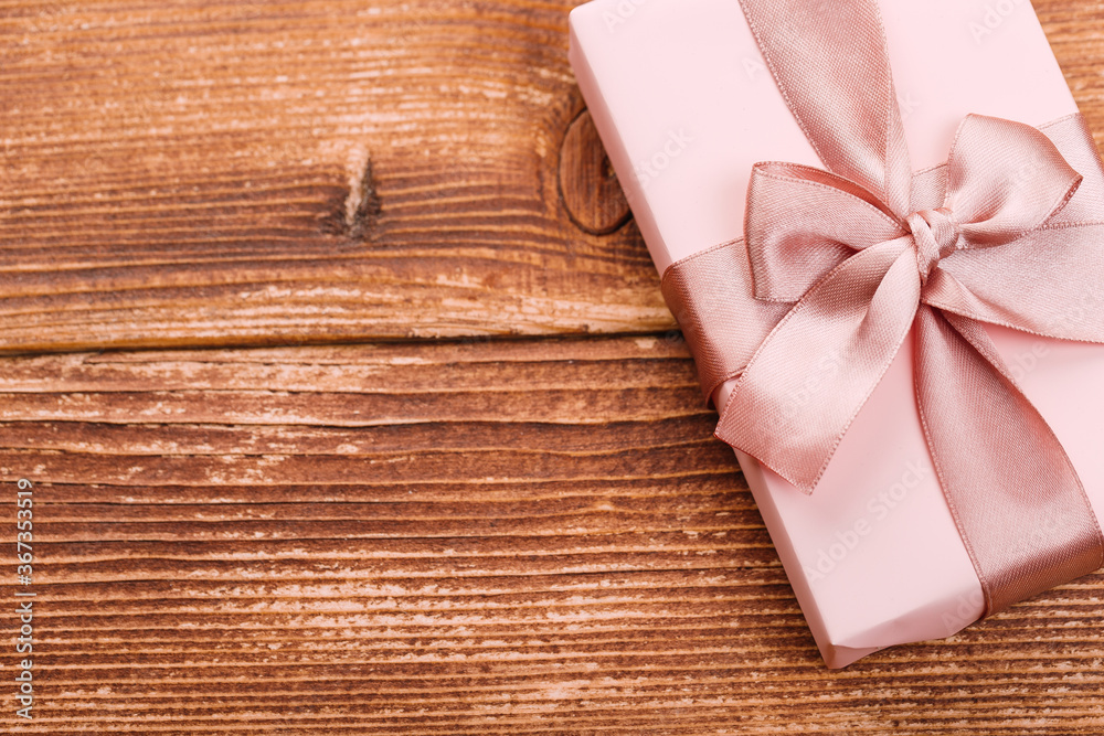 Beautiful gift box with altas bow on a vintage wooden board. holiday card concept.