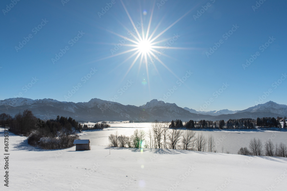 panoramic landscape in winter wirh mountain range and sun on sky panoramic landscape in winter wirh mountain range and sun on sky