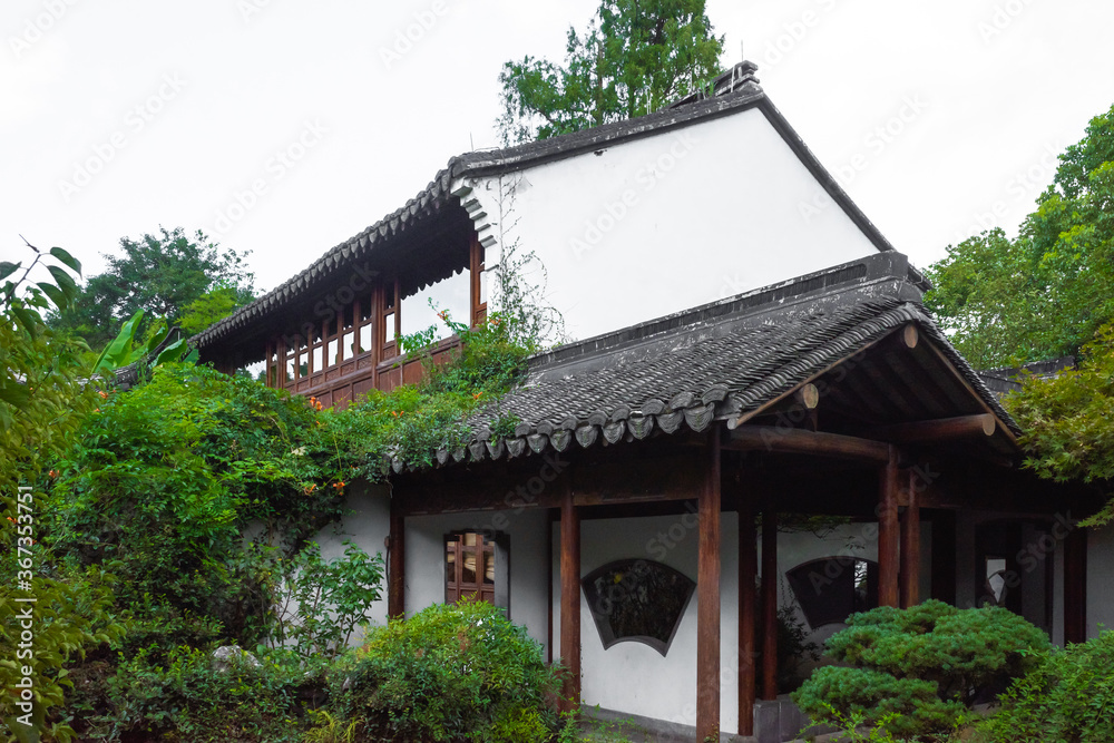 House among trees in Chinese garden in West Lake scenic area in Hangzhou, China House among trees in Chinese garden in West Lake scenic area in Hangzhou, China