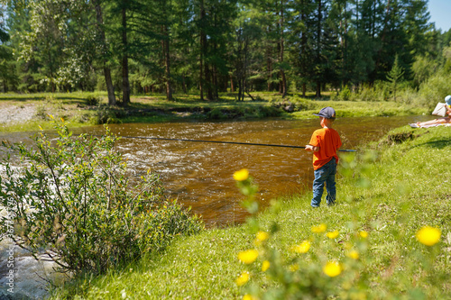 boy fishing on the river
