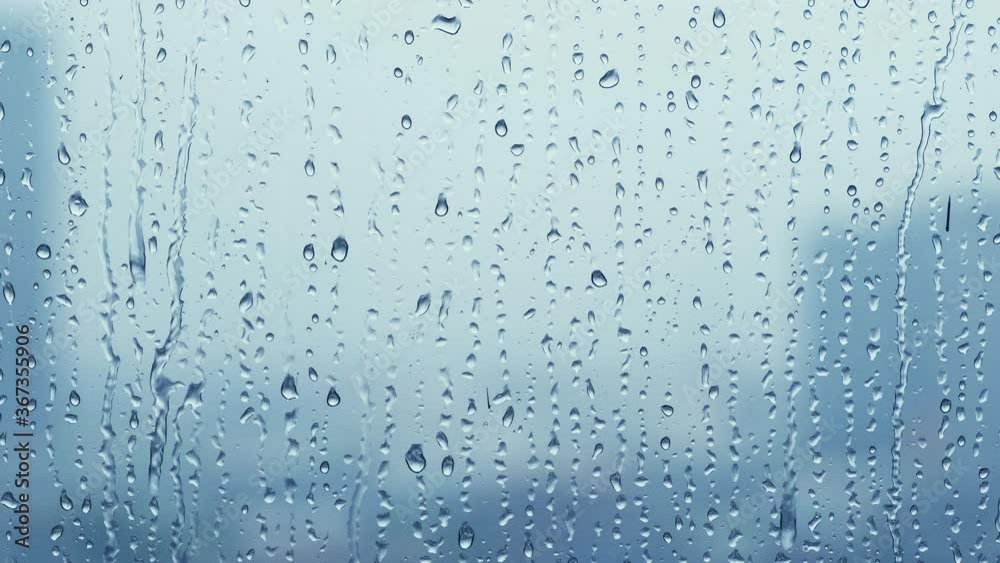 Rain drops on window glasses surface with cloudy background . Rain drops on window glasses surface with cloudy background .