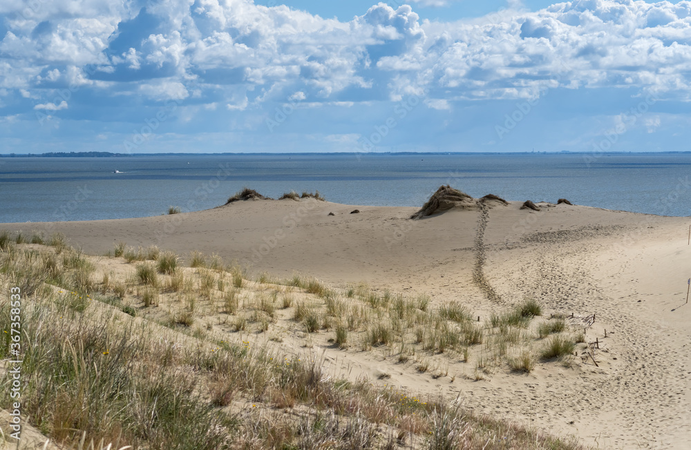 The impressive sight of the Parnidis sand dune rising up to 52 metres between the Curonian Lagoo and the Baltic Sea. Nida, Neringa, Lithuania, in the Curonian Spit National Park The impressive sight of the Parnidis sand dune rising up to 52 metres between the Curonian Lagoo and the Baltic Sea. Nida, Neringa, Lithuania, in the Curonian Spit National Park