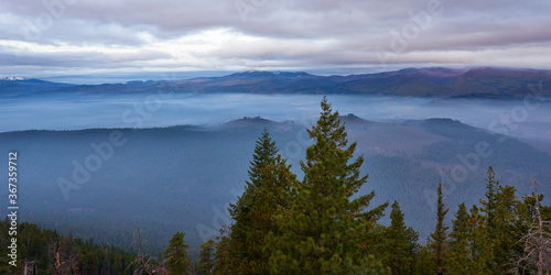 Foggy mountain valley at sunrise. Panoramic view from Green Ridge Lookout in Central Oregon.