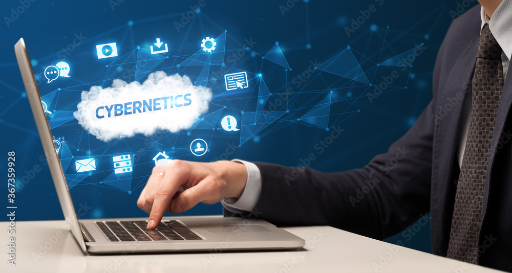 Businessman working on laptop with CYBERNETICS inscription, modern technology concept Businessman working on laptop with CYBERNETICS inscription, modern technology concept