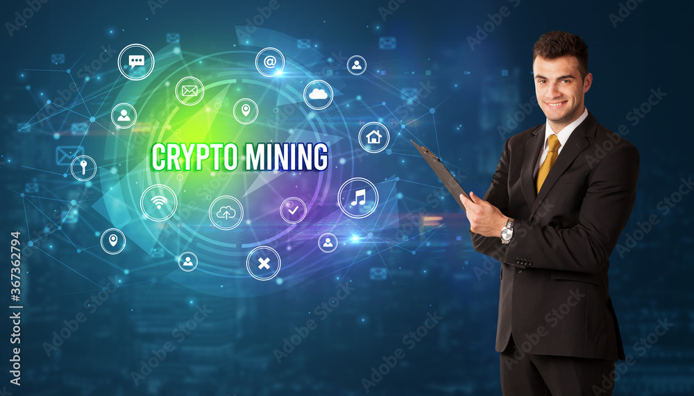 Businessman thinking in front of technology related icons and CRYPTO MINING inscription, modern technology concept Businessman thinking in front of technology related icons and CRYPTO MINING inscription, modern technology concept