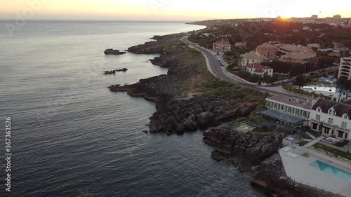 Amazing aerial view at sunset of the little village of Cascais not far from Lisbon in Portugal. The landscape of the city near to the Ocean.  The shoreline to the west has cliffs, attracting tourists.