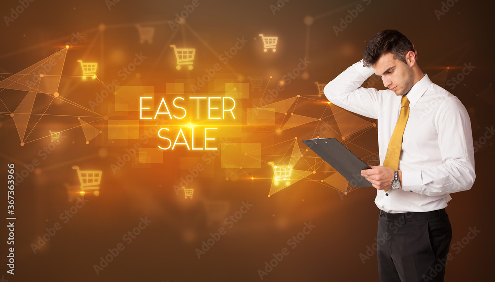 Businessman with shopping cart icons and EASTER SALE inscription, online shopping concept Businessman with shopping cart icons and EASTER SALE inscription, online shopping concept