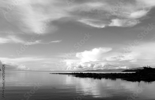 Black & white ocean and lake scenes with dynamic active cloudy skies and water reflections