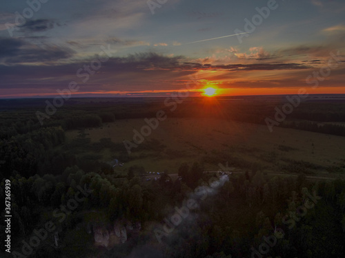 The setting sun illuminates the Chembulat nature reserve on the banks of the Nemda River