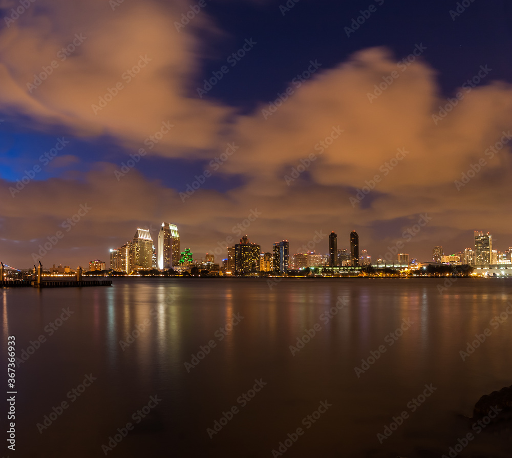 Naklejka premium San Diego Skyline at Sunset Across San Diego Bay From Tidelands Park on Coranado Island,San Diego,California,USA