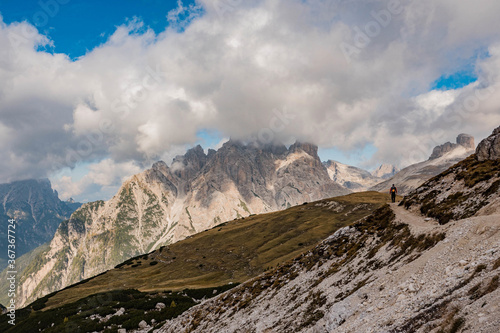 Walker, climber, person on a lonely way through the stony mountains in the italian dolomites, italy