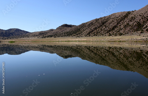 Pristine water scenes with reflections and brilliant blue skies