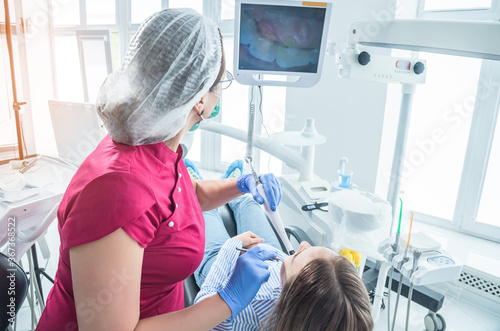 The dentist examines a patient at a reception in the dental office. The concept of health care and treatment in medical facilities