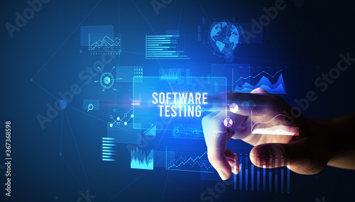 Hand touching SOFTWARE TESTING inscription, new business technology concept