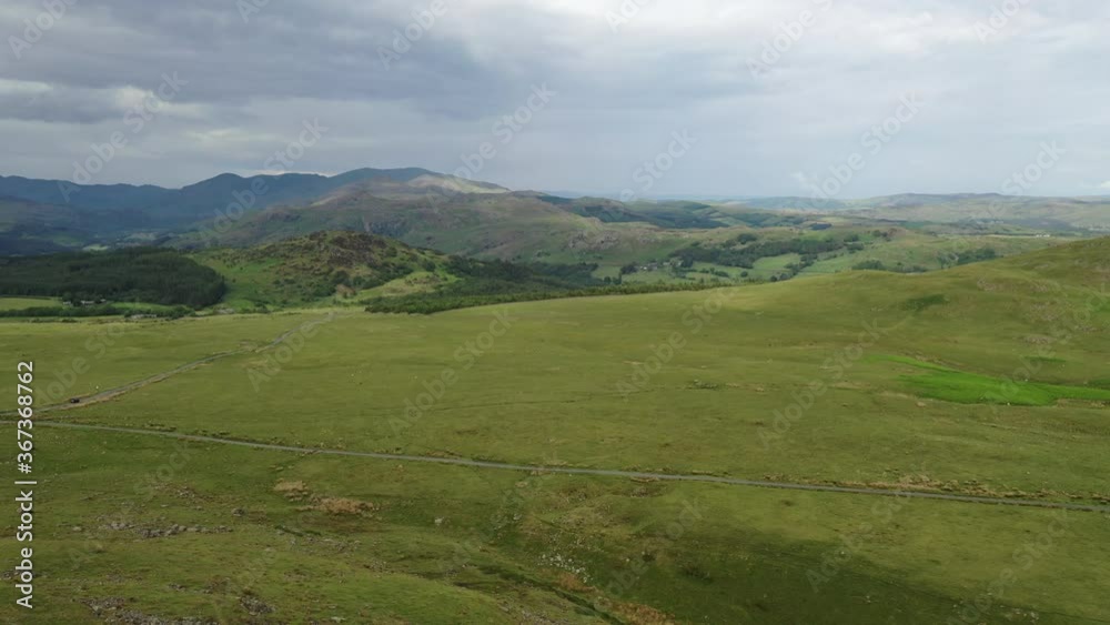 Aerial dropping shot of the open countryside in the Lake District. Aerial dropping shot of the open countryside in the Lake District.