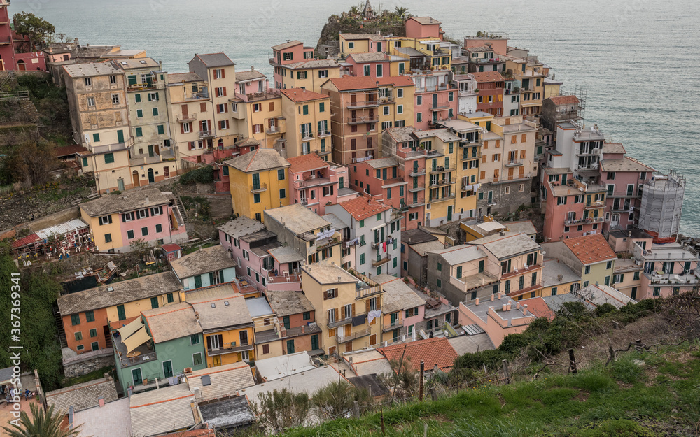 Cinque Terre villages along Ligurian rugged coast, view of its houses built on the cliff above the sea, La Spezia province, Liguria region, Italy.