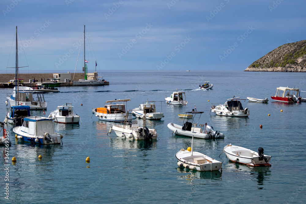Panorama of Komiza, settlement and fishing port on island Vis on Adriatic sea in Croatia
