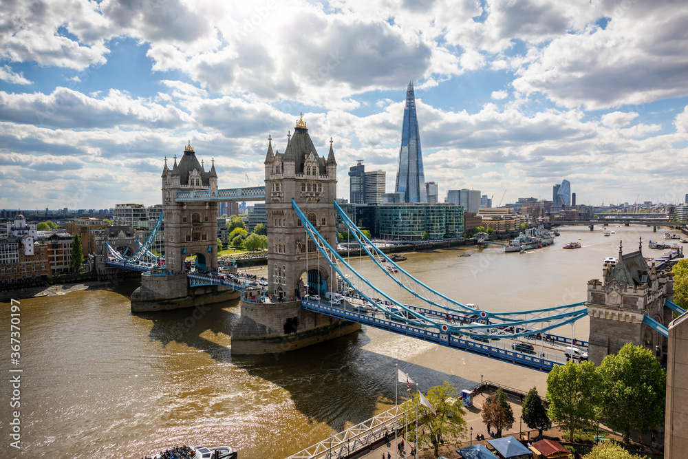 Beautiful view to the Tower Bridge and modern skyline of London along the Thames river on a sunny day, United Kingdom