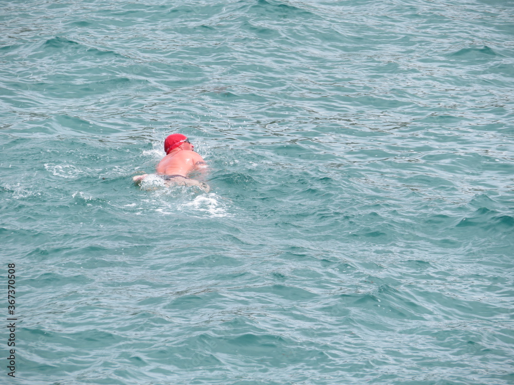Beautiful images of a swimmer on the high seas with very cold water